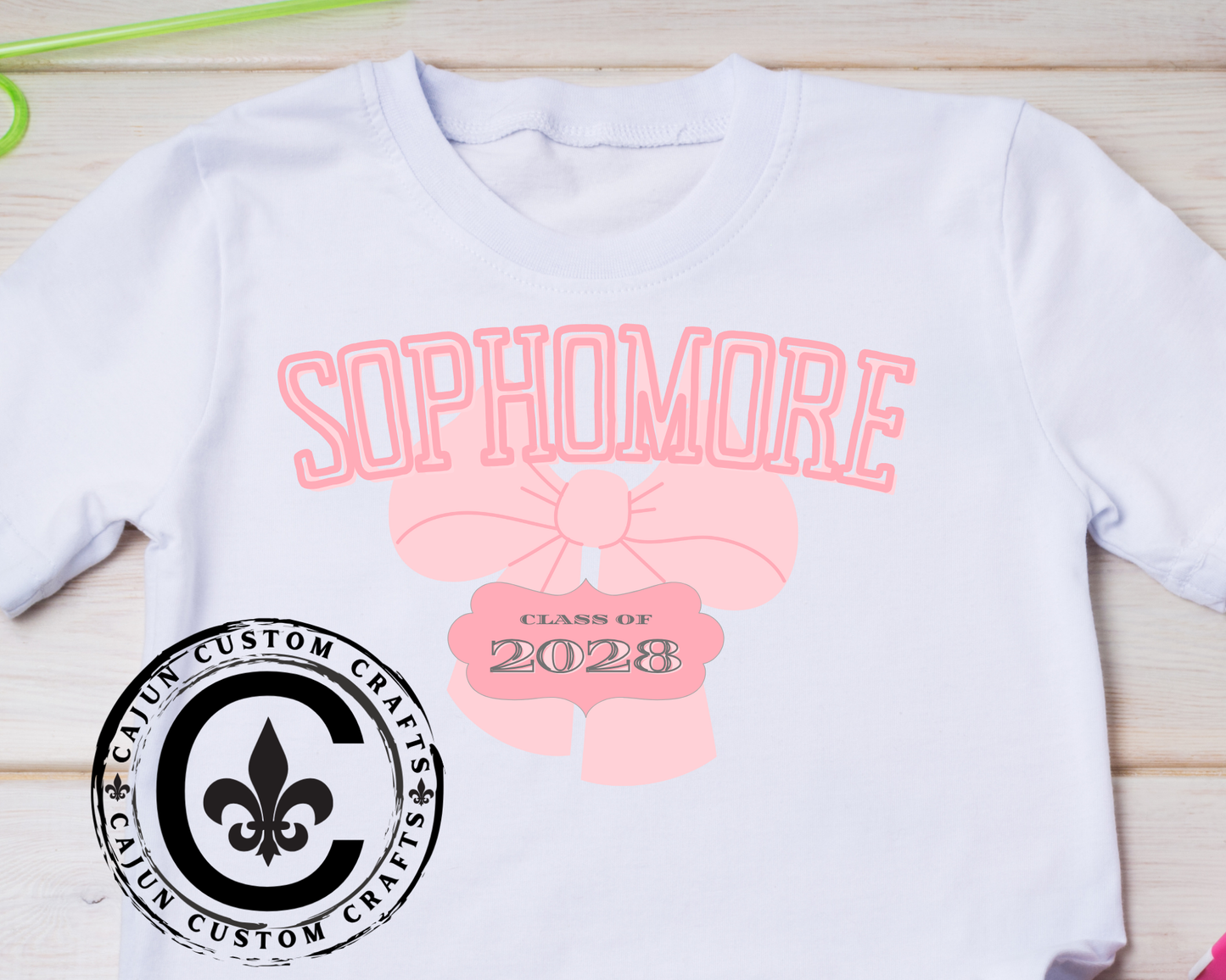 sophomore 2028 with a cute bow on a unisex tshirt, female high school